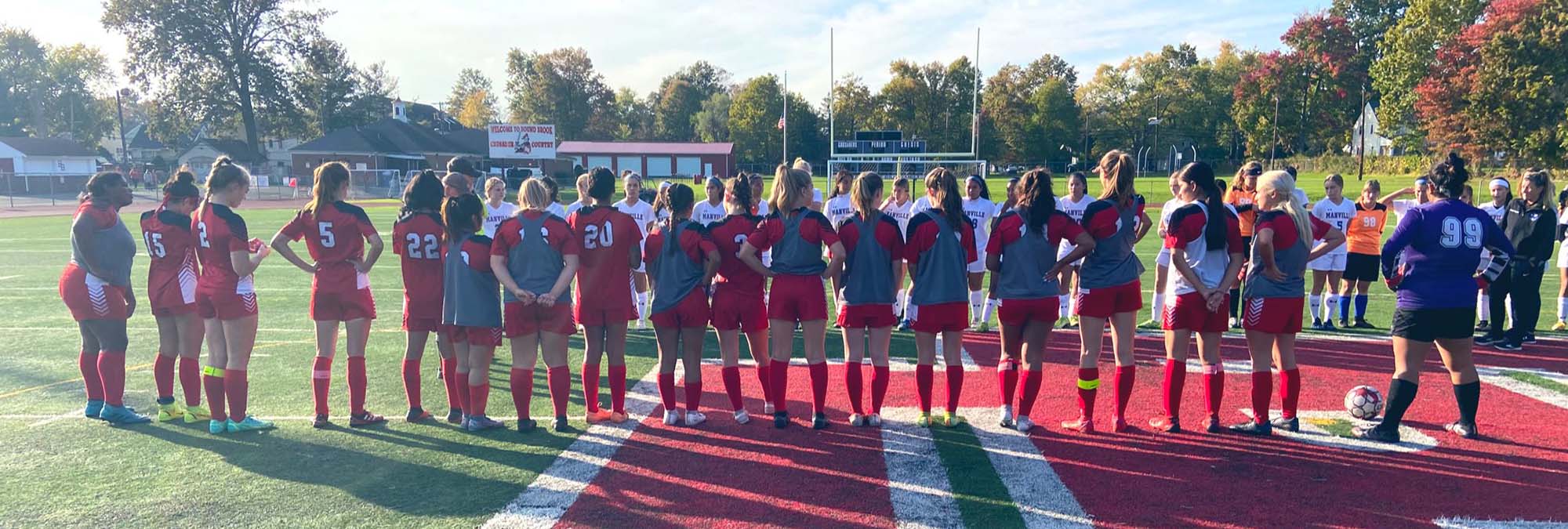 BBHS girls soccer team huddles together before game