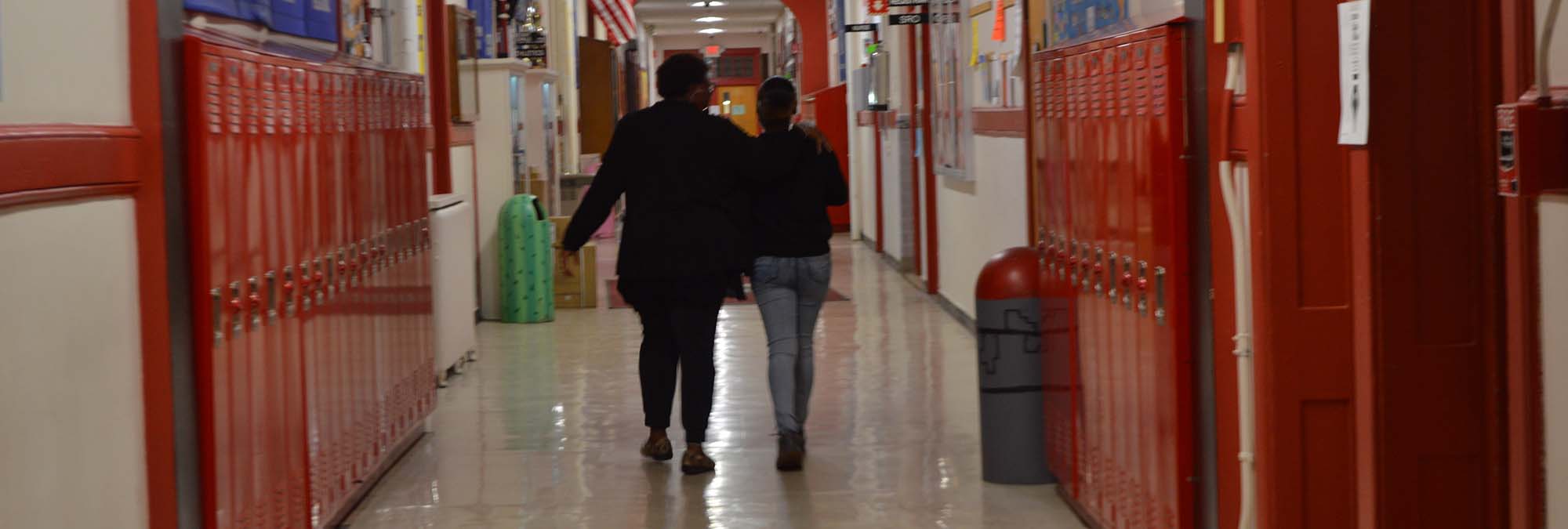 Teacher and student walking together and bonding