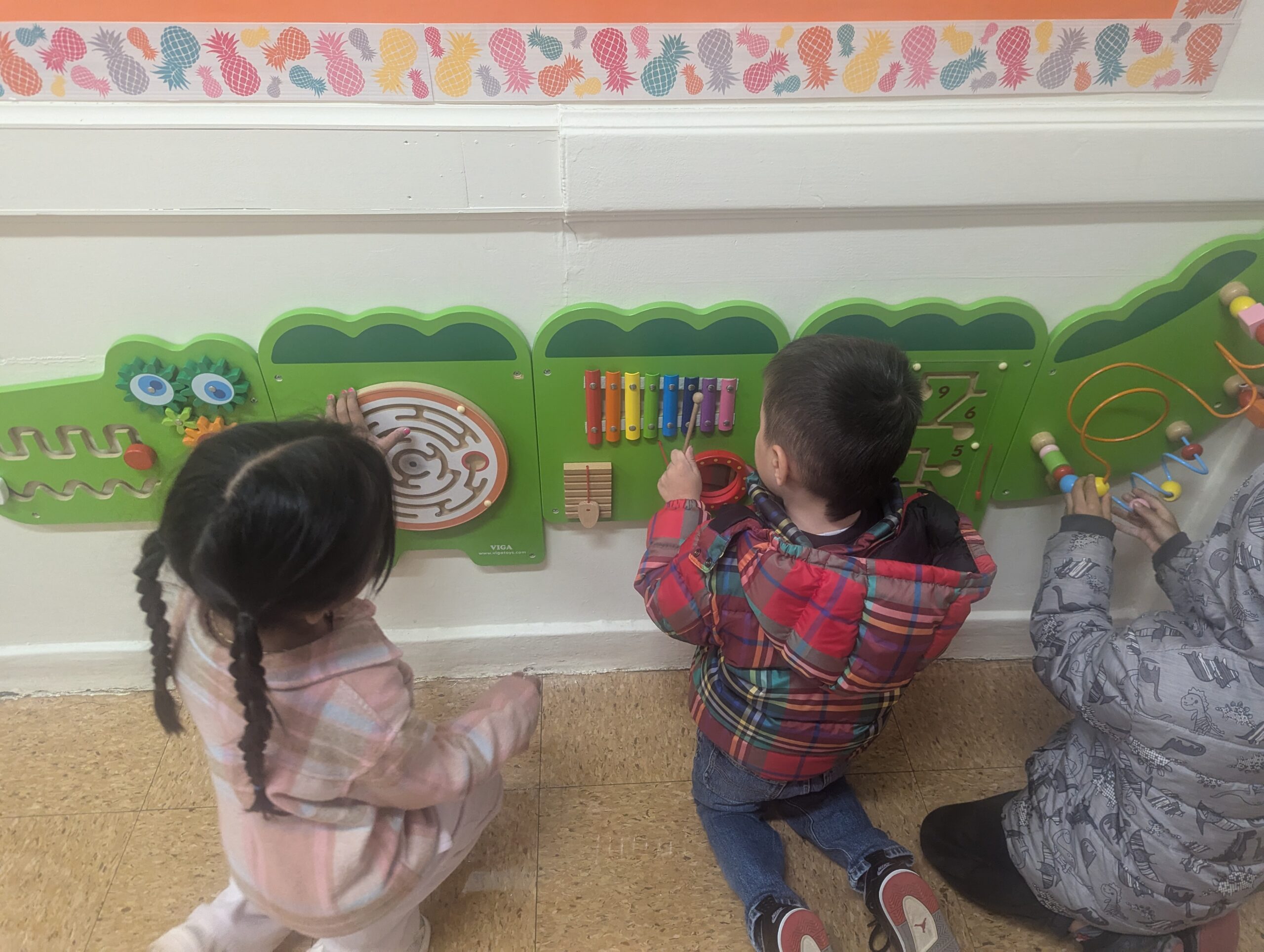 Students use the tactical board in the alligator shaped sensory hallway at LaMonte.
